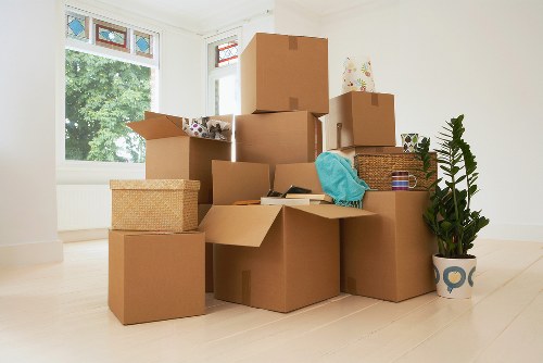 Packed moving boxes and furniture ready for a van service in Finsbury Park